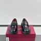 Front view of Ferragamo Men's Black Leather Chunky Sole Loafers displaying the apron toe and gunmetal vamp hardware.