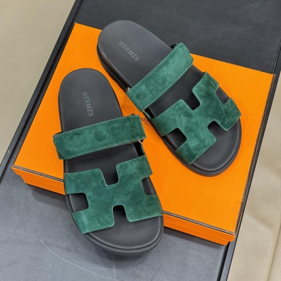 Hermes Chypre Suede Sandals In Dark Green - Top Down View Top-down view of Hermes Chypre dark green suede sandals resting on an orange box