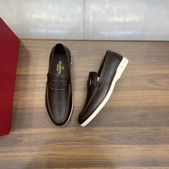Valentino Men's brown loafers displayed beside a red branded box on wooden surface in brown and white