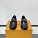 Frontal view of L Men's Major Loafers In Black Grain Leather showing the apron stitching and central metallic initials detail.