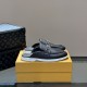 Pair of L Men's Estate Open Back Leather Loafers in black resting on a shoe box in black and white