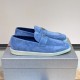 Pair of Prada Men's Blue Suede Loafers Soft Slip On Shoes positioned on grey box