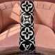 L Women's Medallion Monogram Fringe Black Scarf Black Side View in black and white L Women's Medallion Monogram Fringe Black Scarf draped over a pink sofa showing black main side in black and white