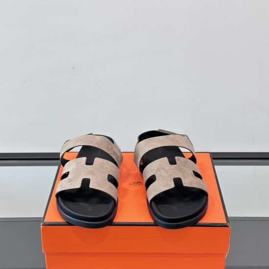 Hermes Genius Sandals In Etoupe Suede Front View in black Front view of Hermes Genius Sandals In Etoupe Suede highlighting the H-cutout upper design in black
