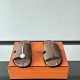 Hermes Izmir Sandals In Beige top-down view showing cutout straps and footbed detail