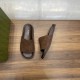 Gucci Brown Suede Slide Sandals Angled View Angled top-down view of Gucci brown suede slide sandals next to packaging box