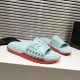 Christian Louboutin Blue and Red Mules Three-Quarter View Pair of Christian Louboutin blue and red mules displayed from a front three-quarter angle