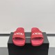 Front-facing view of the bright red slides highlighting the prominent white logo lettering