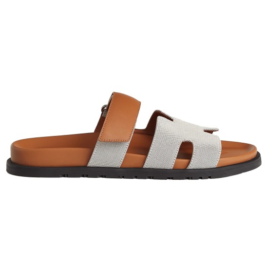 Hermes Chypre Sandals In Grey And Brown Lateral View Side profile of Hermes Chypre Sandals In Grey And Brown showing the contoured footbed and flat sole