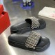 Christian Louboutin Pool Roc black gold spiked slides paired view Top-down angled view of both black slides showcasing the patterned arrangement of gold and silver spikes
