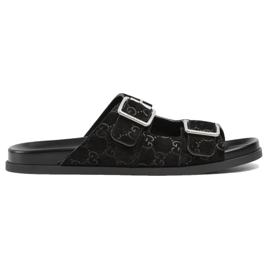 Profile view of black Gucci slide sandals in GG suede with silver buckles