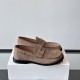 Loewe Men's Suede Penny Loafers In Tan Brown Side Profile Side profile view of Loewe Men's Suede Penny Loafers In Tan Brown placed on a white box