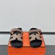 Hermes Genius Sandals in Etoupe Leather front angle display in black