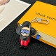 L Women's Vivienne Diver Charm with Packaging L Women's Vivienne Diver Bag Charm resting on a yellow designer display box