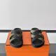Hermes Kazimir Sandals front view in black and green Front facing view of the black and green sandals displaying the toe area and straps