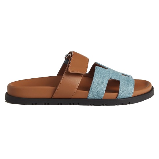 Hermes Chypre Sandals In Blue And Brown Side Profile Hermes Chypre Sandals In Blue And Brown lateral side view showing blue H-strap and brown sole