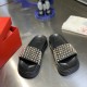 Christian Louboutin Pool Roc black gold spiked slides front view Front upper view of the black slides highlighting the toe beds and detailed spike placement in black and gold