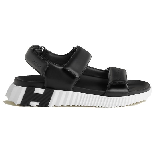 Hermes black leather junior sandals lateral profile showing white ridged sole