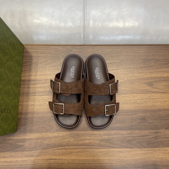 Direct overhead view of brown Gucci slide sandals showing interior brand stamps in brown and silver