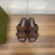 Direct overhead view of brown Gucci slide sandals showing interior brand stamps in brown and silver