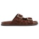Profile view of brown Gucci slide sandals showing suede double straps and silver buckles