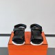 Hermes black leather junior sandals front view highlighting double straps in black and white