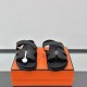 Hermes Black Leather Sandals Front View Front angle view of the pair of black leather sandals displaying the toe area and cutout pattern