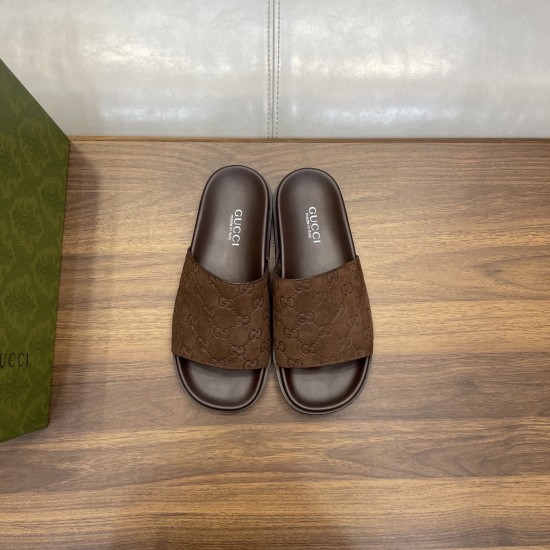 Gucci Brown Suede Slide Sandals Overhead View Direct overhead view of Gucci brown suede slide sandals on wooden surface