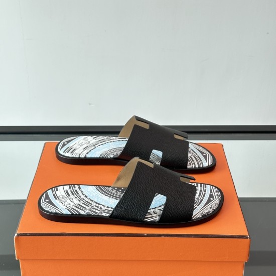 Hermes Izmir Black Leather Printed Sandals - Angled View Hermes Izmir Black Leather Printed Sandals angled view on an orange box