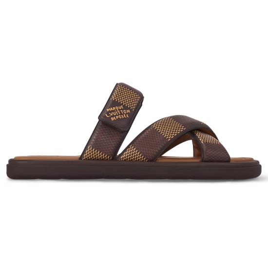 Side Profile Of Brown L Flat Mules Side profile view of the brown L Venice flat mules displaying the strap details