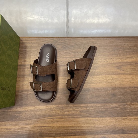 Angled top view of brown Gucci slide sandals next to a green storage box on wood in brown and silver