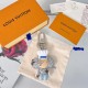 L Women's Vivienne Chef Bag Charm with Packaging L Women's Vivienne Chef Bag Charm And Key Holder Signature resting on a fabric dust bag alongside brand packaging