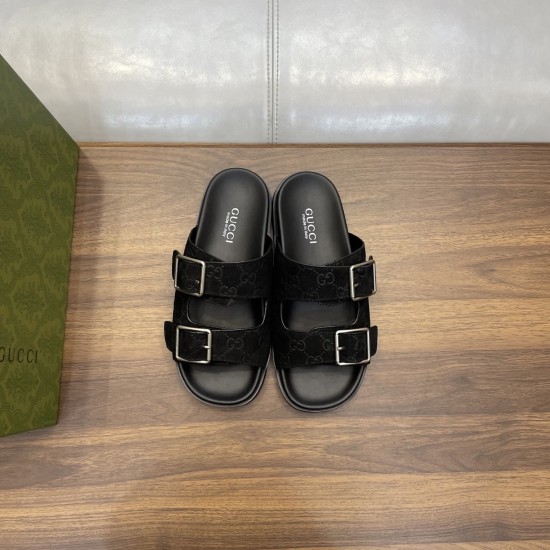 Front overhead view of black Gucci slide sandals featuring dual buckled straps in black and silver