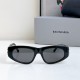 Front view of Balenciaga Women's Bossy Round Sunglasses detailing the black frame and dark tinted lenses