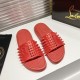 Top angled view of Christian Louboutin Take It Easy red mules on a white surface