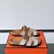 Hermes Chypre Sandals In Grey And Brown Side Display Pair of Hermes Chypre Sandals In Grey And Brown displayed side by side on an orange presentation box