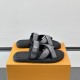 Angled View of Black L Venice Mules on Box Angled view of black L Venice Mules resting on an orange box