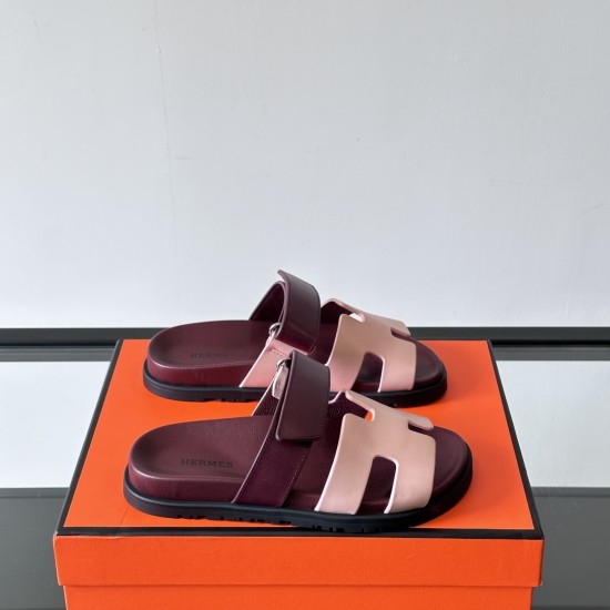 Hermes Chypre Sandals In Red And Beige On Box Three quarter angle of Hermes Chypre Sandals In Red And Beige resting on an orange box
