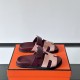 Hermes Chypre Sandals In Red And Beige On Box Three quarter angle of Hermes Chypre Sandals In Red And Beige resting on an orange box