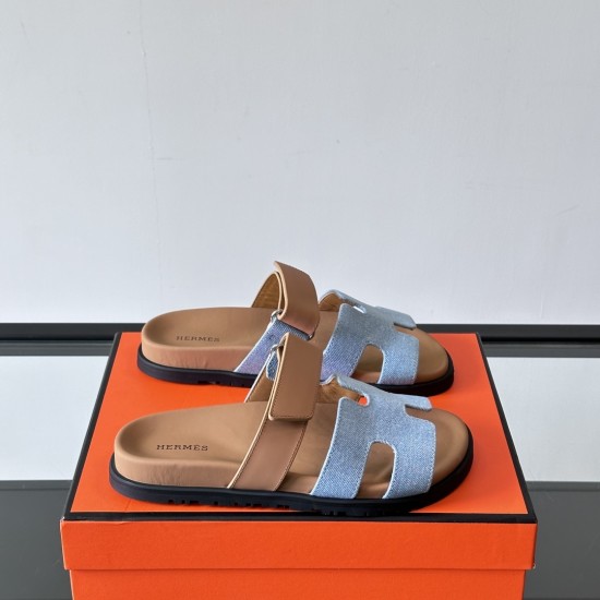 Hermes Chypre Sandals In Blue And Brown Three Quarter Angle Hermes Chypre Sandals In Blue And Brown angled pair resting on an orange box