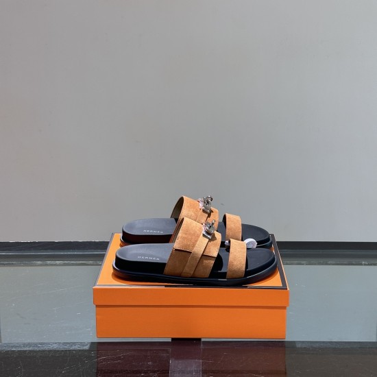 Hermes Jackson Brown Suede Sandals on Box in brown and silver Angled view of Hermes Jackson brown suede sandals resting on an orange presentation box in brown and silver