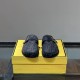 Front angle view of Fendi black slippers displaying rounded toe and straps