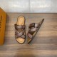 L Venice Mules Brown Angle View Angled top-down view of the brown L Venice Mules next to a branded orange box