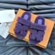Top down view of Hermes Chypre slide sandals in violet on orange box