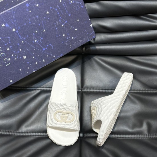 Gucci White Rubber Slide Sandals with Presentation Box Top angle view of Gucci white rubber slide sandals next to a dark blue presentation box