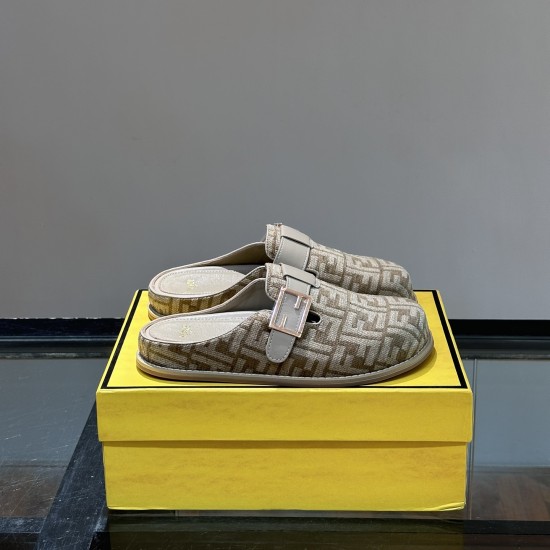 Pair of Fendi beige jacquard logo slip on slippers on yellow box Pair of Fendi beige jacquard logo slip on slippers resting on top of a yellow presentation box