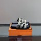 Hermes Jackson Vert Toundra Suede Slide Sandals on Box in silver Pair of Hermes Jackson vert toundra suede slide sandals resting on an orange box in silver