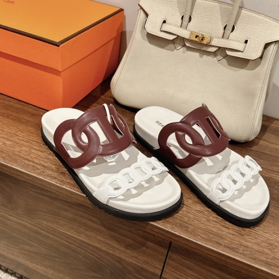 Hermes Sandals Displayed on Wood in White and Red Marsala Hermes sandals in white and red marsala displayed on a wooden surface