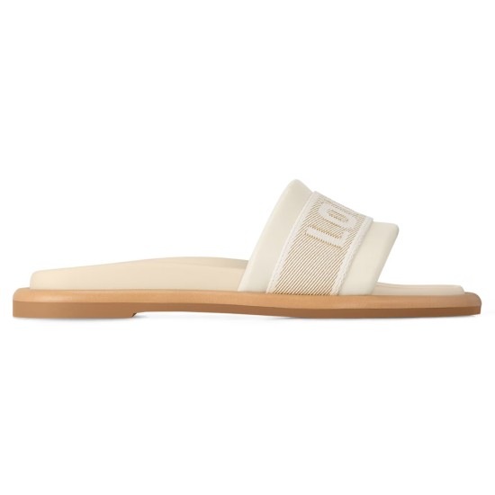 Side profile of white ecru L sandals Side profile view of the white ecru L sandals showing the cushioned strap and flat tan sole
