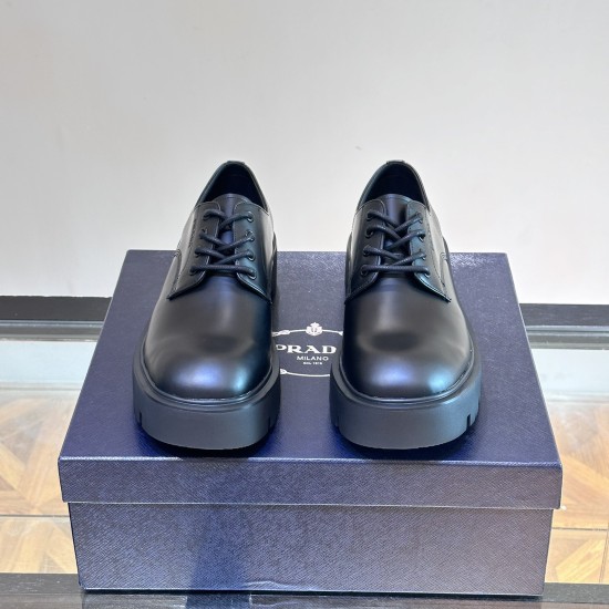 Prada Men's Brushed Leather Derby Shoes in black front view Front view of black Prada Men's Brushed Leather Derby Shoes showing rounded toes and lace-up fastening